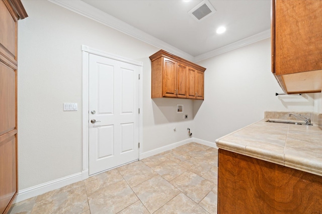 laundry room featuring hookup for an electric dryer, cabinets, sink, hookup for a gas dryer, and ornamental molding