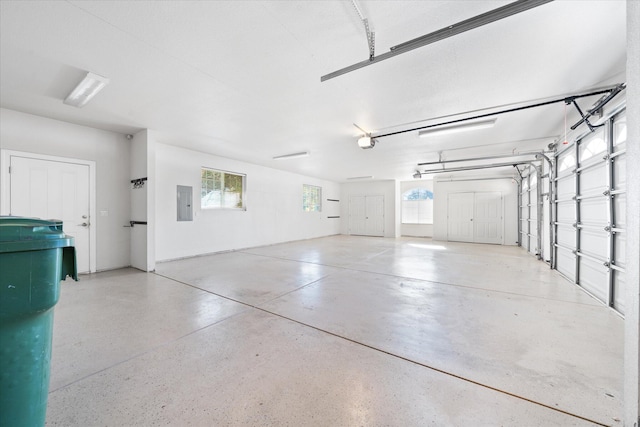 garage with electric panel and a garage door opener