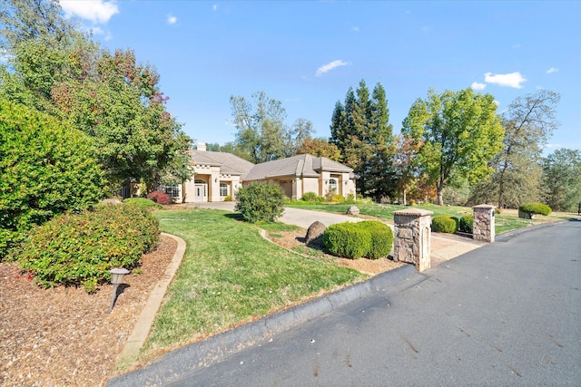 ranch-style home featuring a front yard