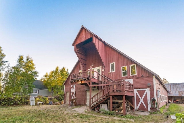 back of house with an outbuilding