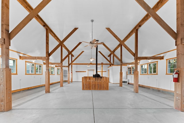 interior space with beam ceiling, ceiling fan, plenty of natural light, and high vaulted ceiling