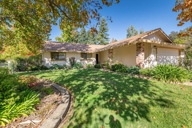 ranch-style house with a front lawn and a garage