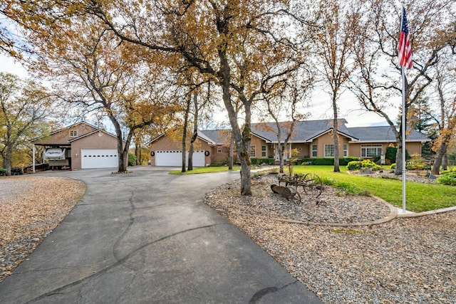 single story home featuring a front yard and a garage