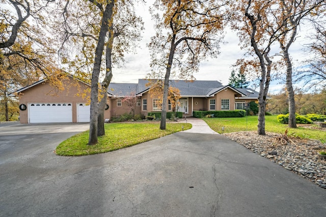 single story home with a front yard and a garage