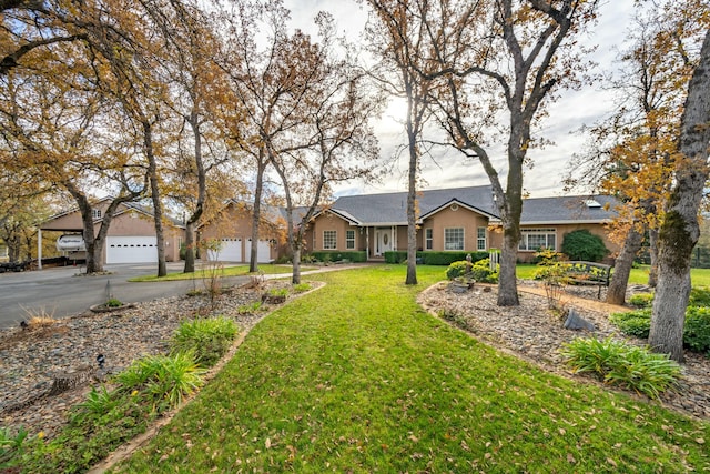 single story home featuring a garage and a front yard