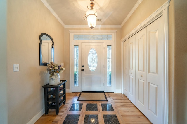 entryway with crown molding and light hardwood / wood-style floors