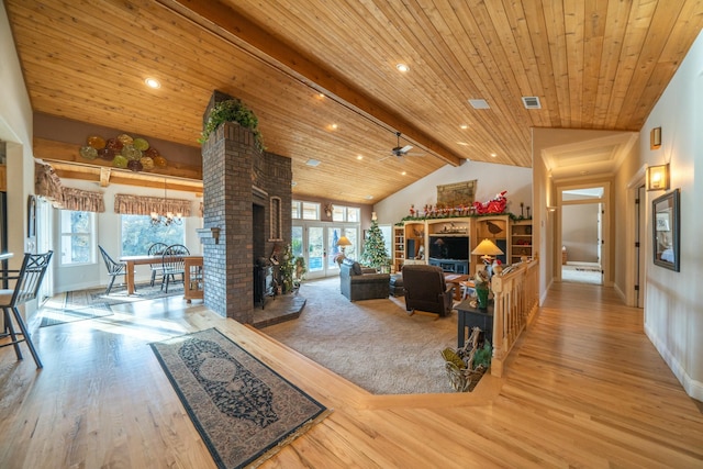 living room featuring hardwood / wood-style floors, lofted ceiling with beams, plenty of natural light, and wood ceiling