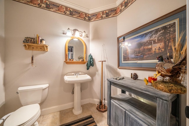 bathroom with tile patterned flooring, toilet, and crown molding