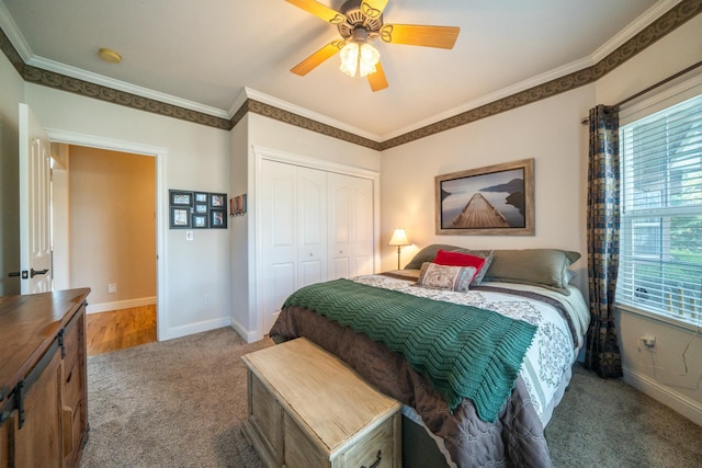 bedroom featuring carpet flooring, a closet, ceiling fan, and ornamental molding