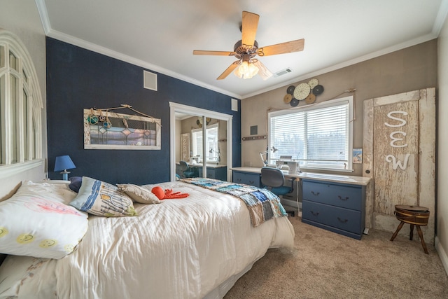 bedroom featuring a closet, light colored carpet, ceiling fan, and crown molding