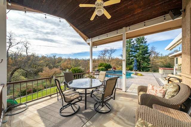 view of patio / terrace with a swimming pool with hot tub and ceiling fan