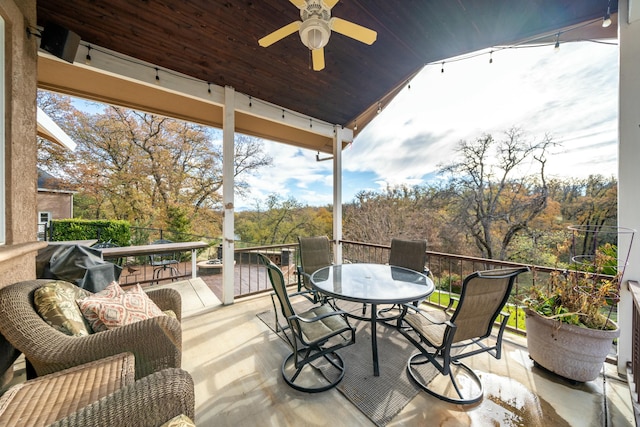 wooden deck featuring ceiling fan and a grill