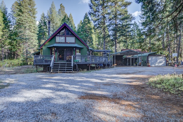 view of front facade featuring a deck and a garage