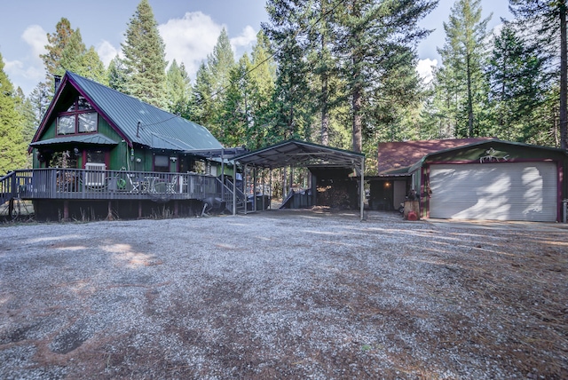 view of front of property with a wooden deck, a garage, and a carport