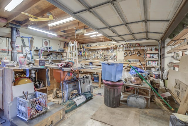 garage with a garage door opener and a workshop area