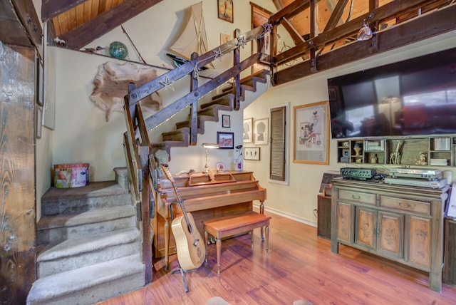 stairway with hardwood / wood-style floors, vaulted ceiling with beams, and wood ceiling