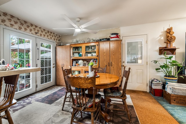 dining space with ceiling fan and carpet