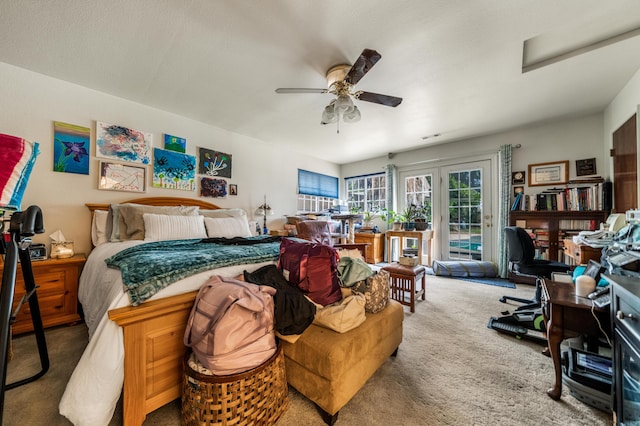 carpeted bedroom featuring access to exterior and ceiling fan