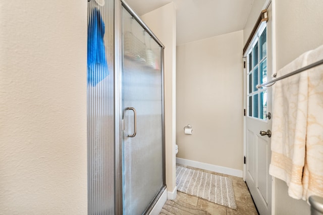 bathroom with toilet and an enclosed shower