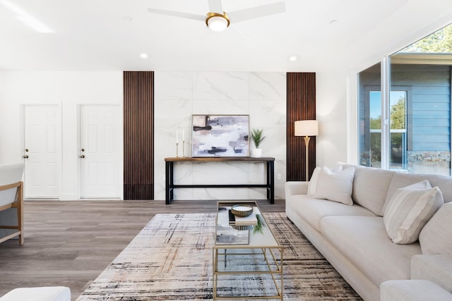 living room with hardwood / wood-style flooring and ceiling fan