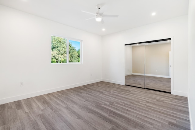 unfurnished bedroom featuring a closet, ceiling fan, and light hardwood / wood-style floors