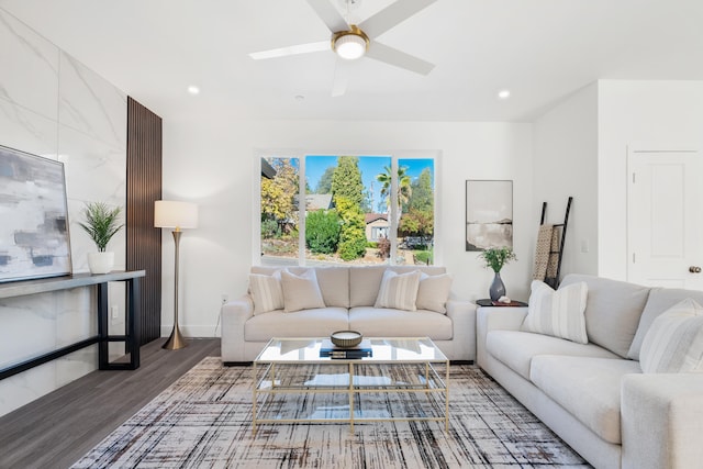 living room with dark wood-type flooring and ceiling fan