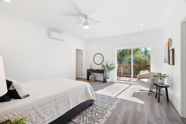 bedroom featuring light hardwood / wood-style flooring, access to exterior, an AC wall unit, and ceiling fan