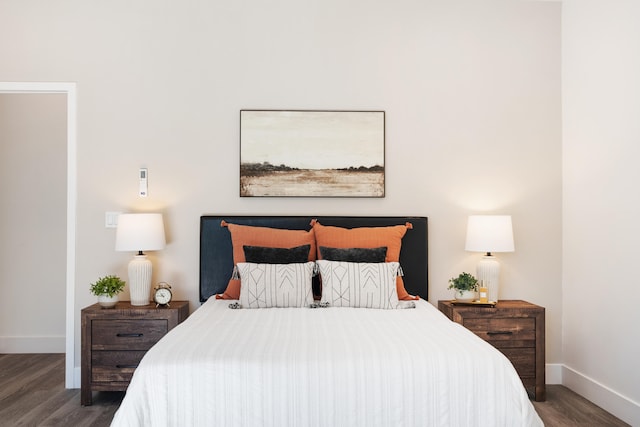 bedroom with dark hardwood / wood-style floors