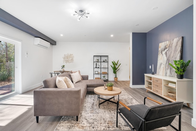 living room featuring a wall mounted air conditioner and light hardwood / wood-style floors