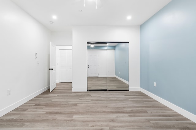 unfurnished bedroom with a closet, ceiling fan, and light hardwood / wood-style flooring