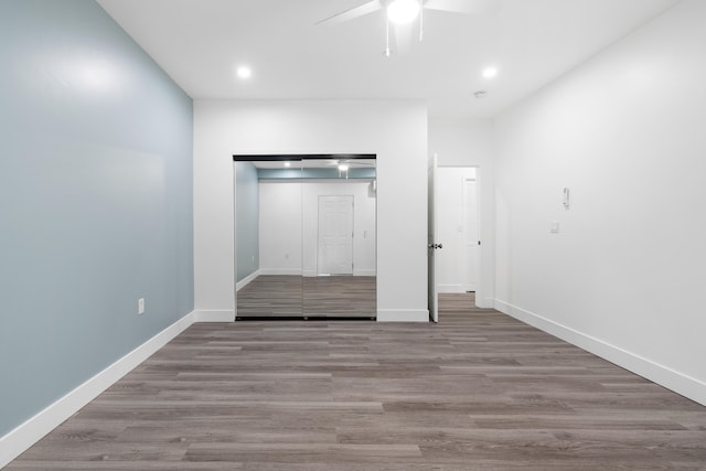 unfurnished bedroom featuring a closet, ceiling fan, and light hardwood / wood-style flooring