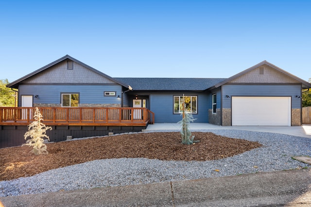 ranch-style house with a wooden deck and a garage