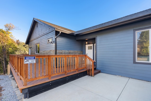 exterior space with a wooden deck and a patio area