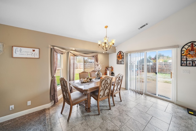 dining space featuring a healthy amount of sunlight, lofted ceiling, and a chandelier