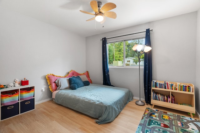 bedroom with hardwood / wood-style floors and ceiling fan