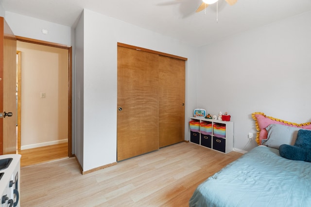 bedroom featuring hardwood / wood-style floors, a closet, and ceiling fan