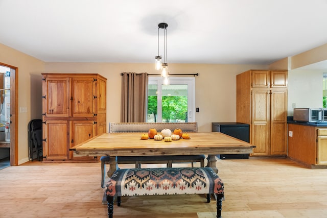 dining space with light wood-type flooring