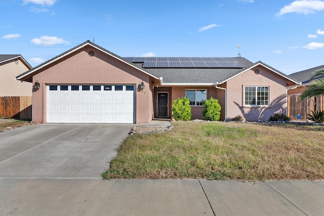 single story home featuring a front yard, solar panels, and a garage