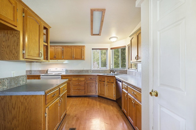 kitchen featuring white range, exhaust hood, sink, stainless steel dishwasher, and light hardwood / wood-style floors