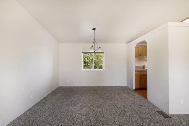 unfurnished dining area with dark carpet