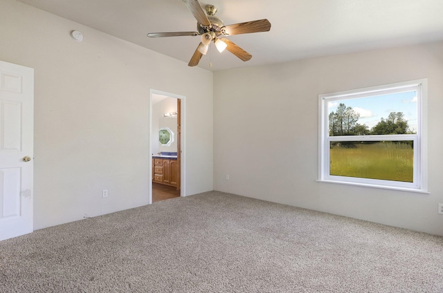 carpeted spare room with ceiling fan