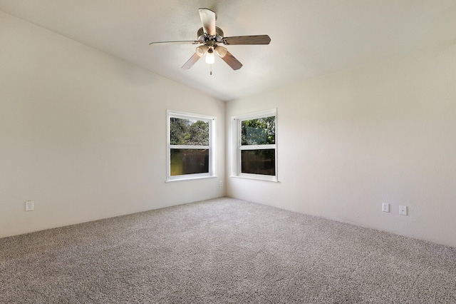 carpeted spare room with ceiling fan and lofted ceiling