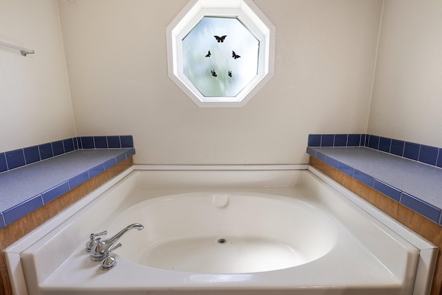 bathroom with a tub to relax in