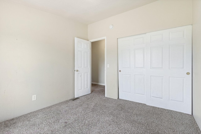 unfurnished bedroom with carpet and a closet