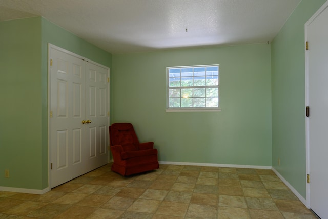 unfurnished room with a textured ceiling