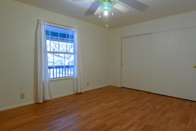 unfurnished bedroom featuring a closet, light wood-type flooring, and ceiling fan