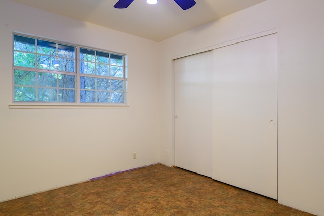 unfurnished bedroom featuring a closet, ceiling fan, and carpet floors