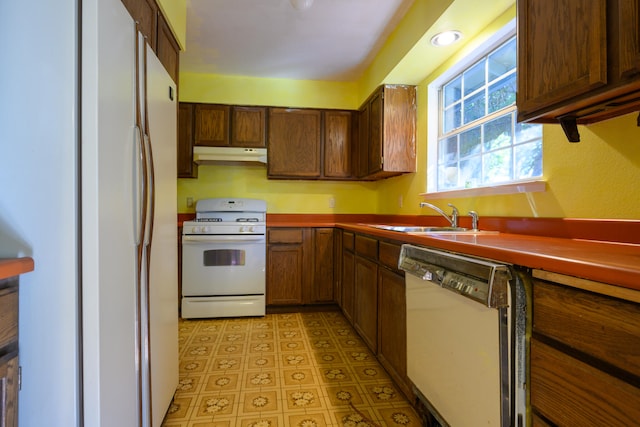 kitchen featuring sink and white appliances