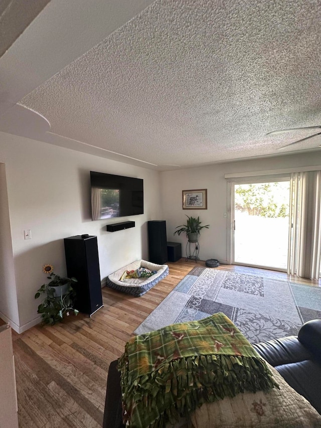 living room with hardwood / wood-style floors and a textured ceiling