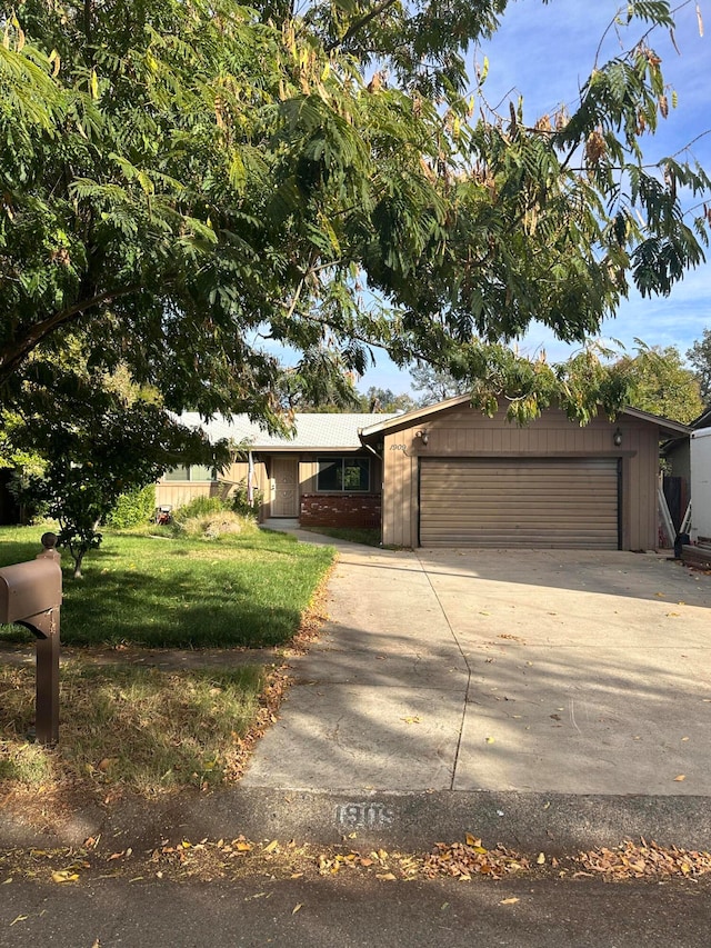 view of front of property with a garage and a front lawn